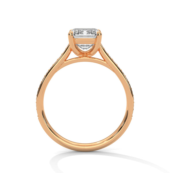 The Celestial Elegance Ring features a striking emerald-cut diamond embraced by a delicate band adorned with shimmering pave stones. A timeless piece that symbolizes everlasting love and sophistication.