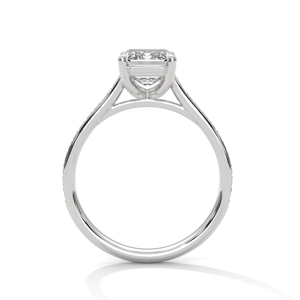 The Celestial Elegance Ring features a striking emerald-cut diamond embraced by a delicate band adorned with shimmering pave stones. A timeless piece that symbolizes everlasting love and sophistication.