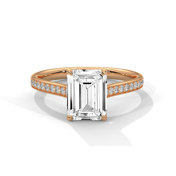 The Celestial Elegance Ring features a striking emerald-cut diamond embraced by a delicate band adorned with shimmering pave stones. A timeless piece that symbolizes everlasting love and sophistication.
