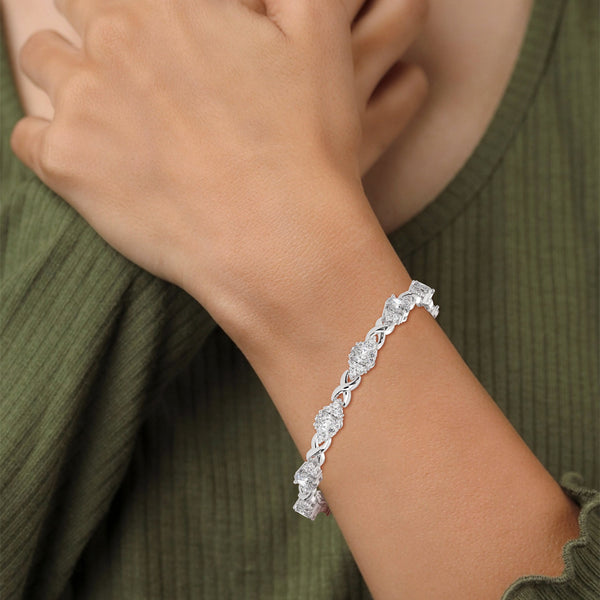 This exquisite tennis bracelet features 62 emerald-shaped diamonds, totaling 7.01 carats. With a 6.50-inch length, it is a stunning accessory that offers a perfect balance of brilliance and sophistication.