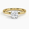 A sleek and modern solitaire ring featuring a round brilliant diamond in a classic four-prong setting atop a refined white gold band.