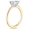 Solstice Grace is a minimalist masterpiece, showcasing an emerald-cut diamond in a classic four-prong setting with a smooth, polished band that radiates refined simplicity.