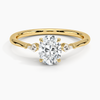 An icy-sleek three-stone ring crowned with a dazzling oval diamond that gleams like winter sunlight.