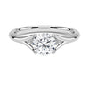 A modern solitaire with sculptural grace, the Seraphine Crest features elegantly arched prongs lifting a brilliant round diamond in a soft, sweeping embrace.