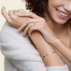 A symbol of harmony and devotion, the Lunara Grace features a round brilliant center flanked by perfectly matched side stones on a gracefully tapered band.