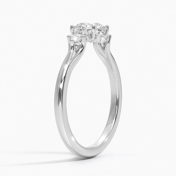 A symbol of harmony and devotion, the Lunara Grace features a round brilliant center flanked by perfectly matched side stones on a gracefully tapered band.