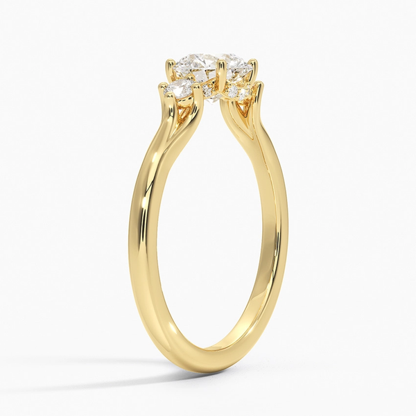 A symbol of harmony and devotion, the Lunara Grace features a round brilliant center flanked by perfectly matched side stones on a gracefully tapered band.