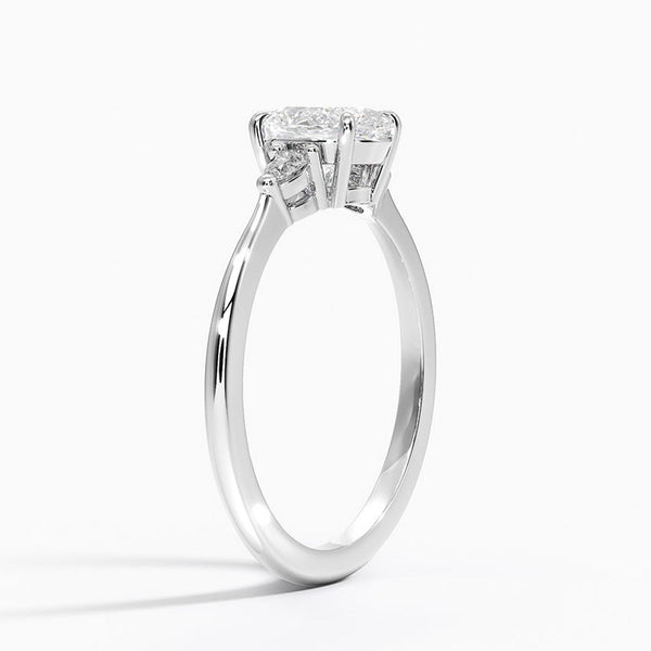 An elegant three-stone ring featuring a radiant oval center gem embraced by soft pear-cut side stones.