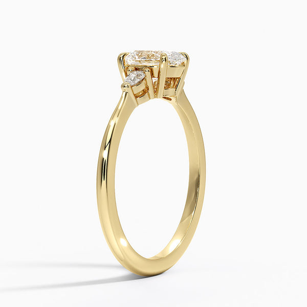 An elegant three-stone ring featuring a radiant oval center gem embraced by soft pear-cut side stones.