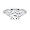 The Virelle Bloom ring features a brilliant round diamond flanked by marquise and pavé-set stones, evoking the soft, organic elegance of blossoming petals.