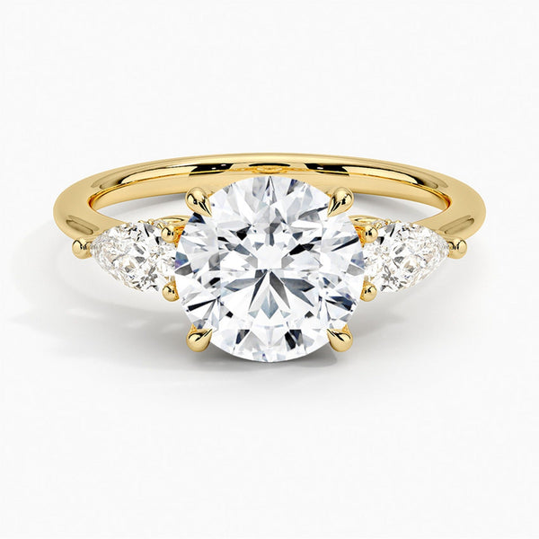 The Virelle Bloom ring features a brilliant round diamond flanked by marquise and pavé-set stones, evoking the soft, organic elegance of blossoming petals.