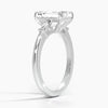 The Solmaris Crest ring showcases a commanding emerald-cut diamond framed by trapezoid side stones, exuding modern elegance and architectural beauty.