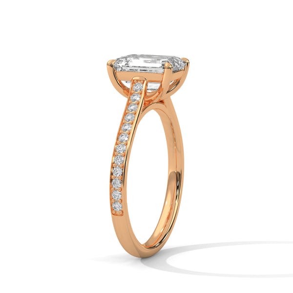 The Celestial Elegance Ring features a striking emerald-cut diamond embraced by a delicate band adorned with shimmering pave stones. A timeless piece that symbolizes everlasting love and sophistication.