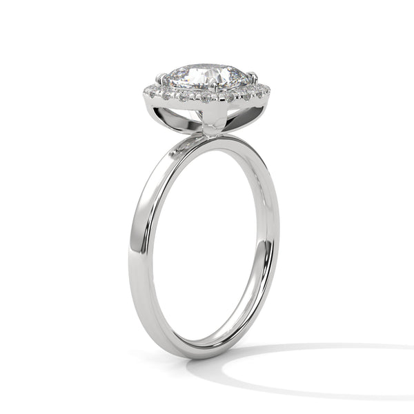 A soft cushion-shaped halo embraces a brilliant round lab-grown diamond — a romantic take on radiant sparkle.
