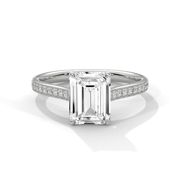 The Celestial Elegance Ring features a striking emerald-cut diamond embraced by a delicate band adorned with shimmering pave stones. A timeless piece that symbolizes everlasting love and sophistication.
