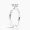 A sleek and modern solitaire ring featuring a round brilliant diamond in a classic four-prong setting atop a refined white gold band.