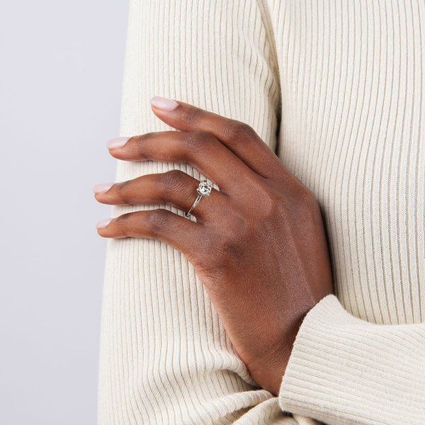 A sleek and modern solitaire ring featuring a round brilliant diamond in a classic four-prong setting atop a refined white gold band.