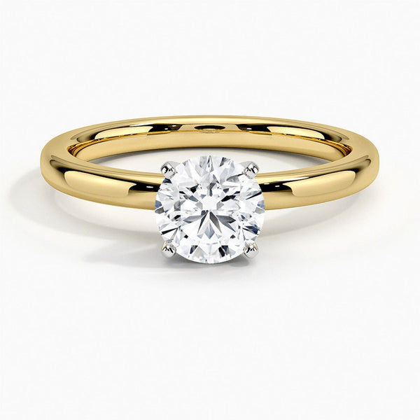 A sleek and modern solitaire ring featuring a round brilliant diamond in a classic four-prong setting atop a refined white gold band.