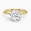 Elodie Whisper enchants with its delicate silhouette and double claw prongs that gently embrace a brilliant round diamond, floating effortlessly atop a slender white gold band.