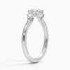 A symbol of harmony and devotion, the Lunara Grace features a round brilliant center flanked by perfectly matched side stones on a gracefully tapered band.