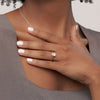 A round brilliant solitaire embraced by an intricate vine-inspired setting, intertwining elegance and organic artistry.