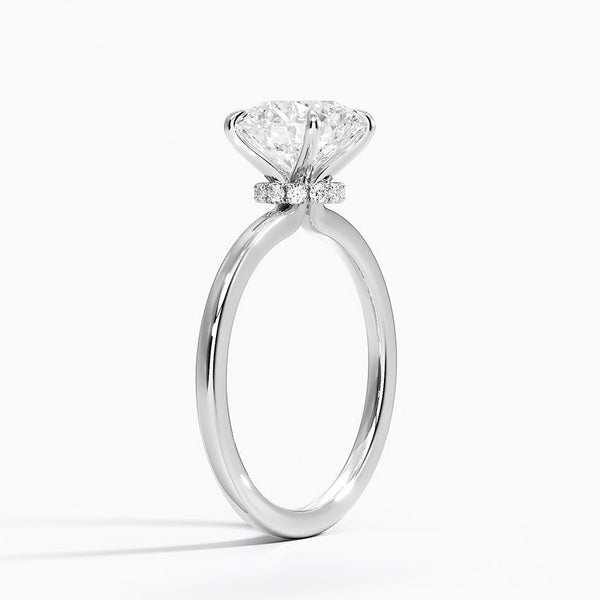 A round brilliant solitaire embraced by an intricate vine-inspired setting, intertwining elegance and organic artistry.