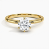 A refined solitaire ring featuring a round brilliant diamond held in a six-prong trellis setting, paired with a polished white gold band.