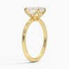 Celestia Crest features a stunning oval diamond elevated by a hidden halo and intricate claw prongs, set atop a high-polish band for a flawless blend of sparkle and sophistication.