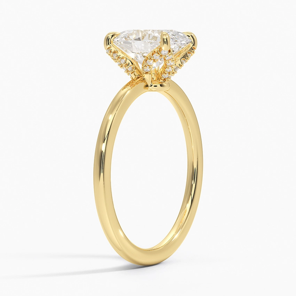Celestia Crest features a stunning oval diamond elevated by a hidden halo and intricate claw prongs, set atop a high-polish band for a flawless blend of sparkle and sophistication.
