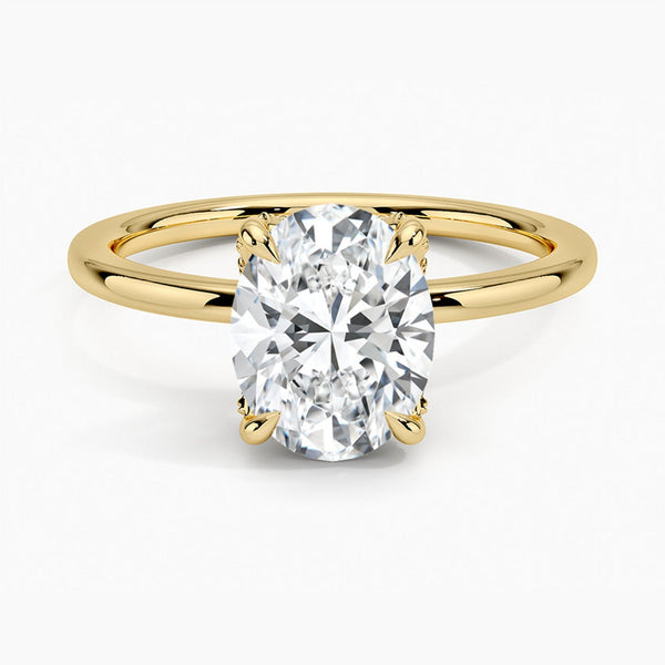 Celestia Crest features a stunning oval diamond elevated by a hidden halo and intricate claw prongs, set atop a high-polish band for a flawless blend of sparkle and sophistication.