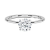 Celestia Crown radiates refined luxury, with a hidden halo of diamonds encircling the base of a dazzling round center stone in a sleek white metal setting.