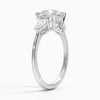 The Virelle Bloom ring features a brilliant round diamond flanked by marquise and pavé-set stones, evoking the soft, organic elegance of blossoming petals.