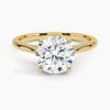 A sweeping cathedral-style solitaire ring with hidden diamond accents and a round brilliant center, blending elegance and modern refinement.